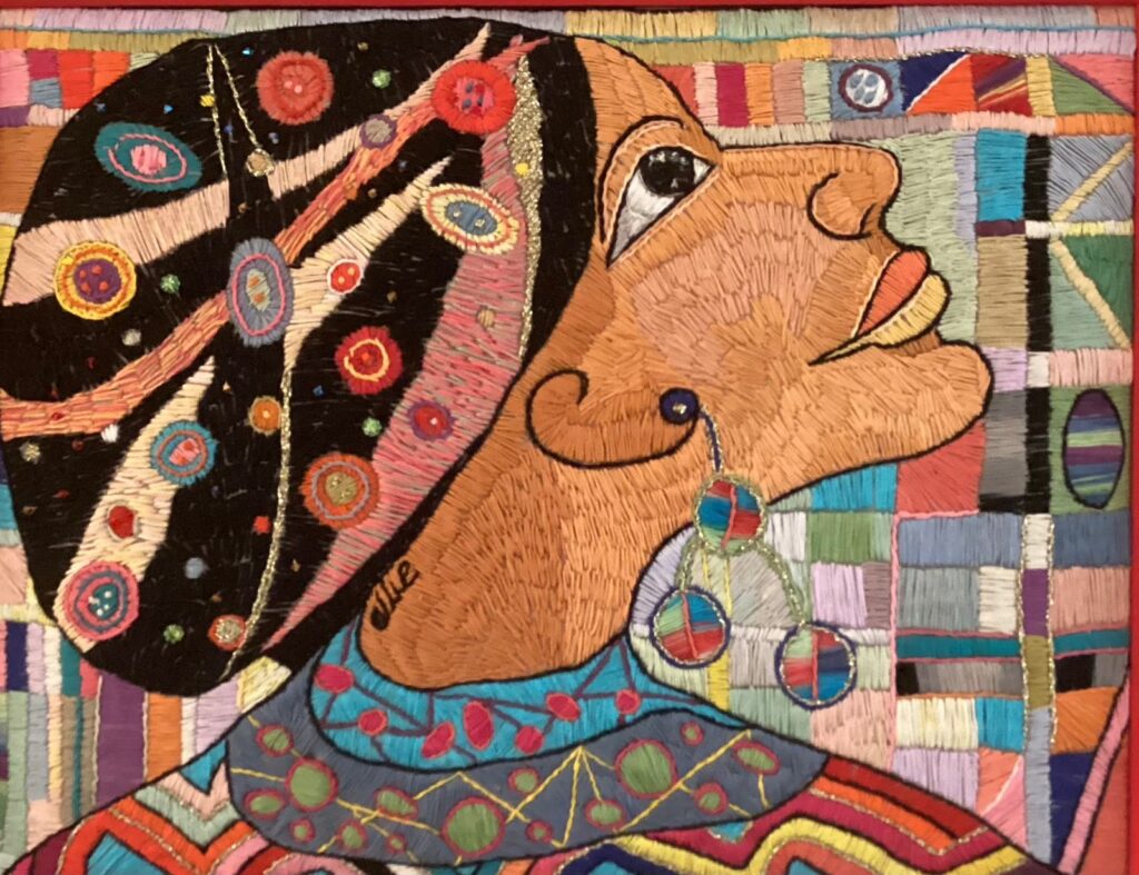 125F, Lady with Be-jeweled Cap, Fiber art - silk threads on linen Dimensions: Don't have measurements Collection: Available